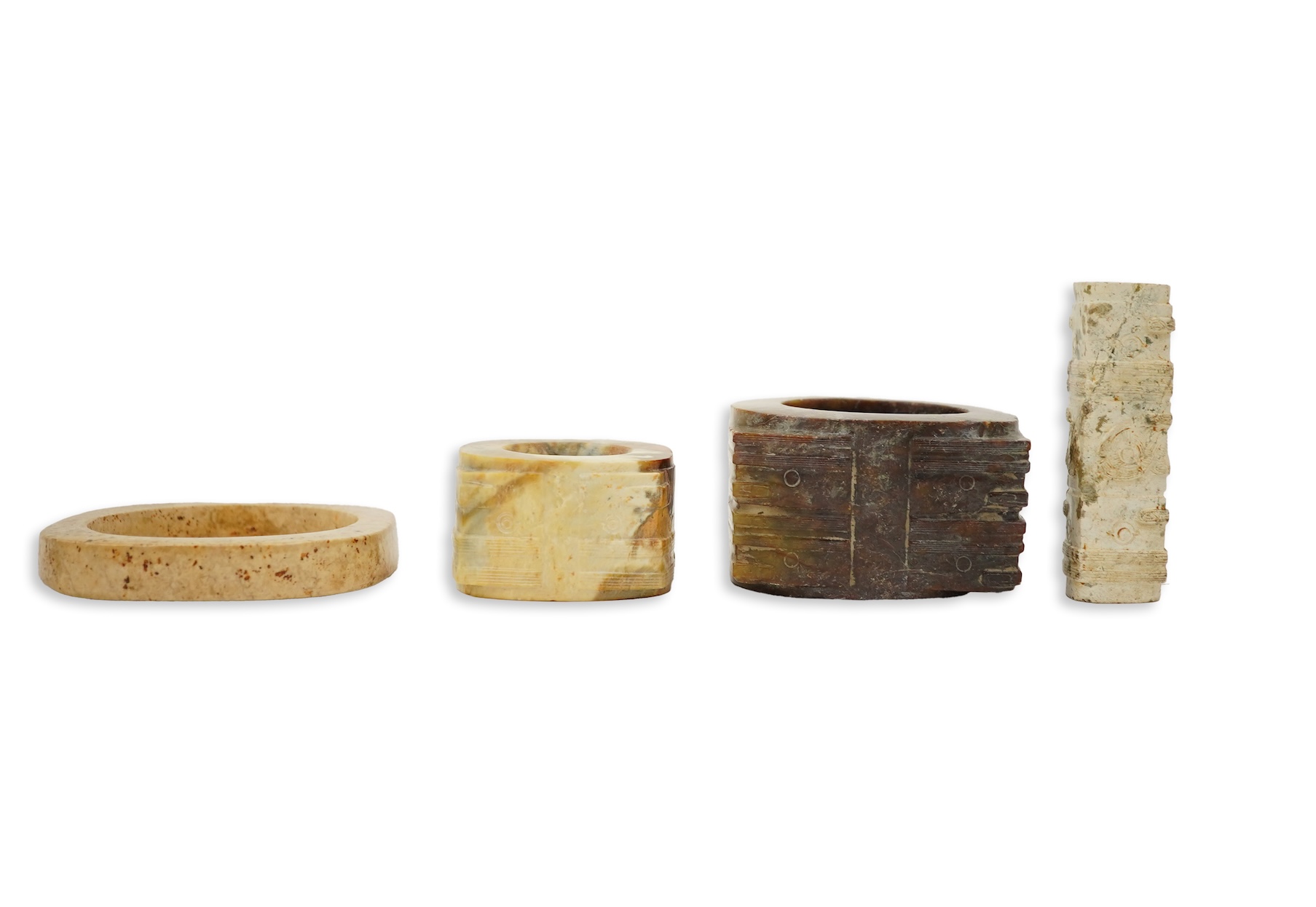 Four Chinese archaistic hardstone or burnt jade cong or cylinders